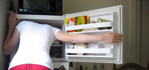 Woman With Head In Freezer