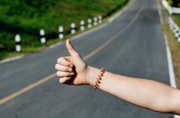 Thumb Out Hitchhiking On Highway