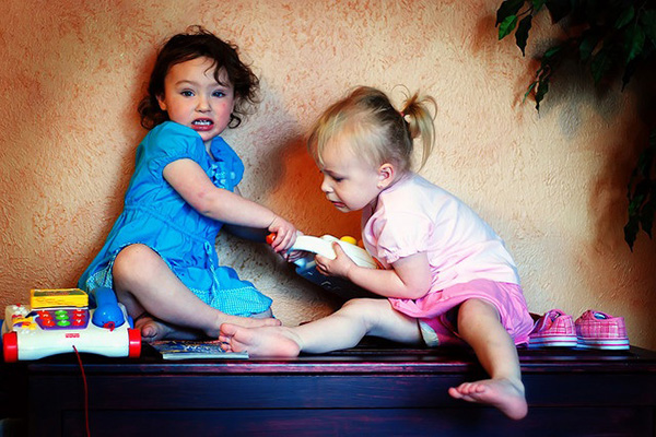 children fighting over a toy