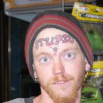 man with stupid tattooed on his forehead
