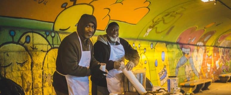 two men prepare to serve the hungry
