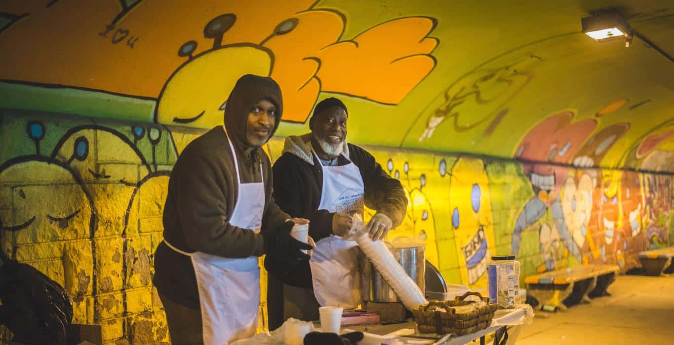 two men prepare to serve the hungry