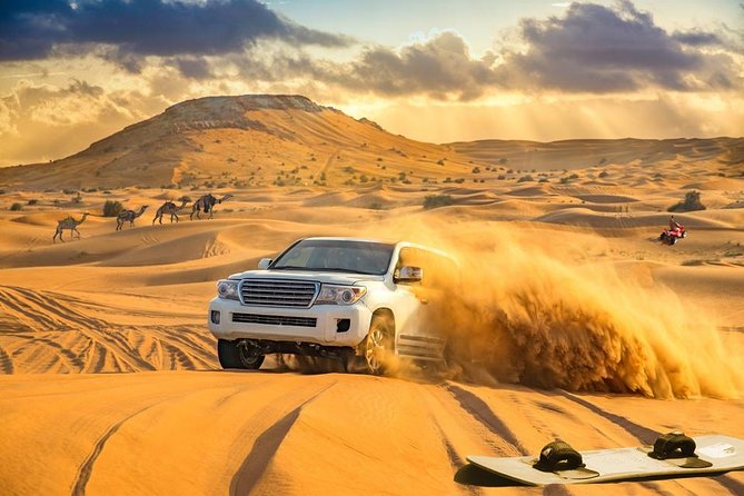 a vehicle crosses the sand outside of Dubai